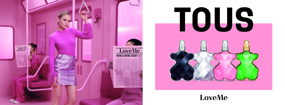 Werbebanner für das Parfum „LoveMe“ von Tous. Links sitzt eine Frau in einem pink beleuchteten U-Bahn-Wagen und liest eine Zeitung mit der Überschrift „LoveMe“. Im Vordergrund steht eine weitere Frau in pinkem Pullover und silbernem Rock, die sich an einer Haltestange festhält. Rechts auf weißem Hintergrund mit pinkem Rechteck sind vier Parfumflakons in Bärenform zu sehen – in Schwarz, Silber, Pink und Grün. Darüber steht groß „TOUS“, darunter „LoveMe“.